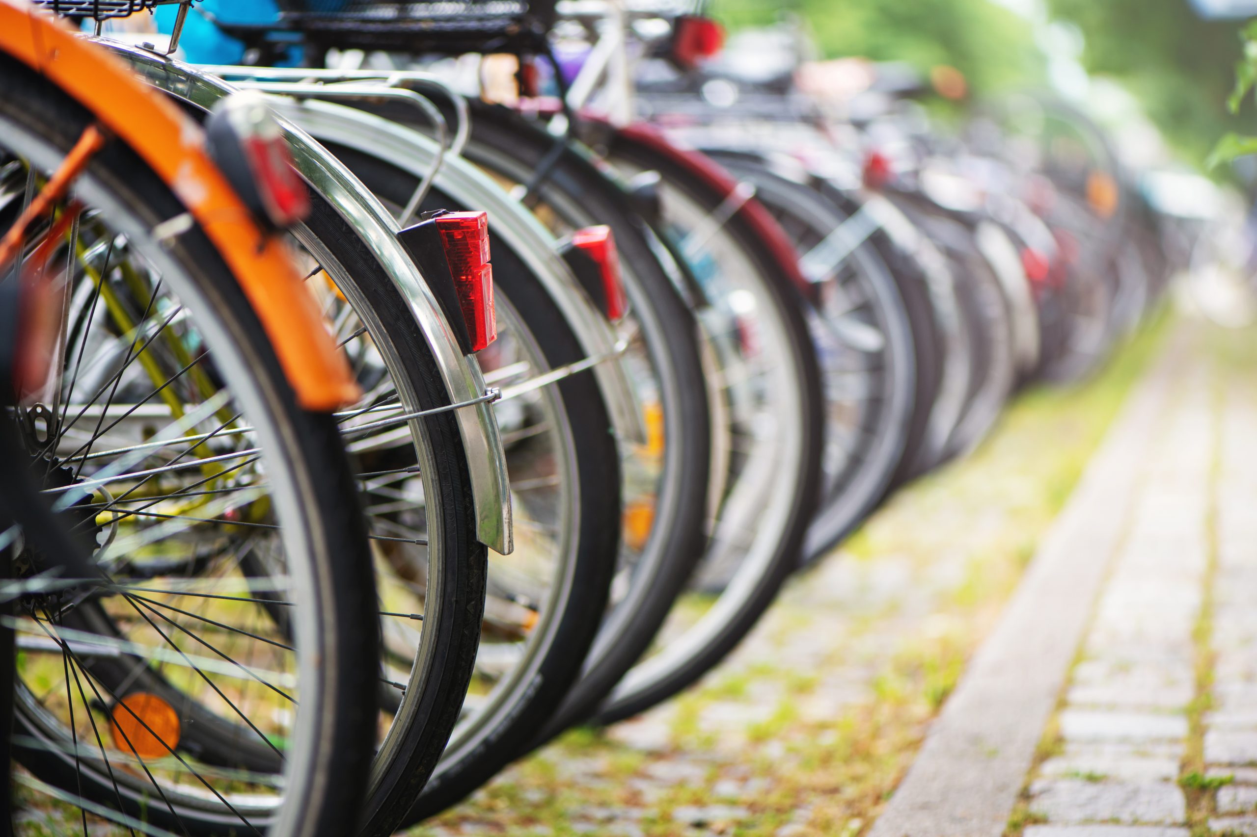 Group of bicycles in the row on parking for bikes in big European city.